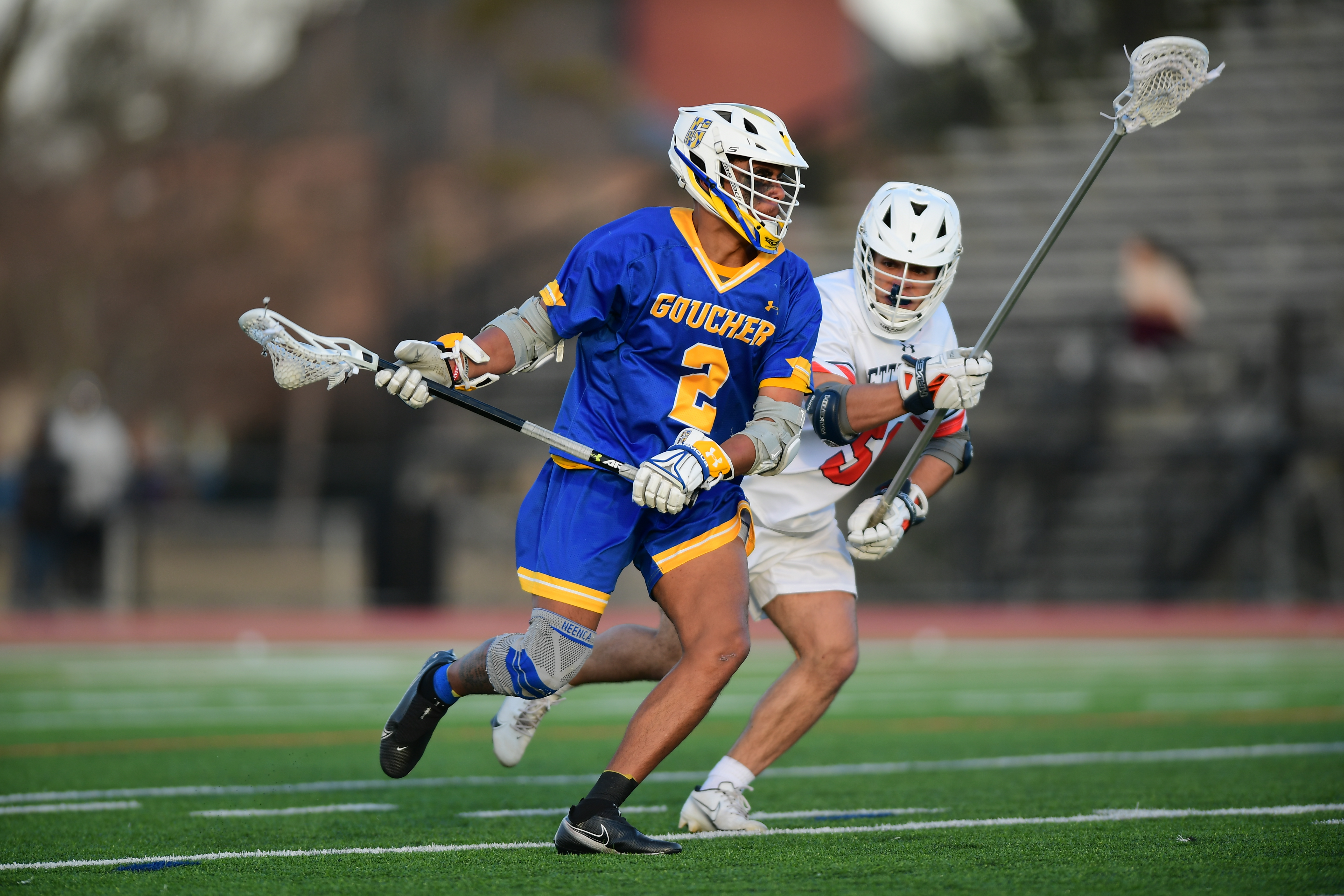 2 students play lacrosse
