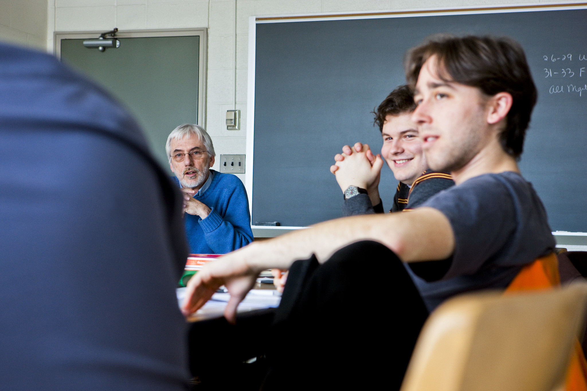 A professor has a discussion with his class.