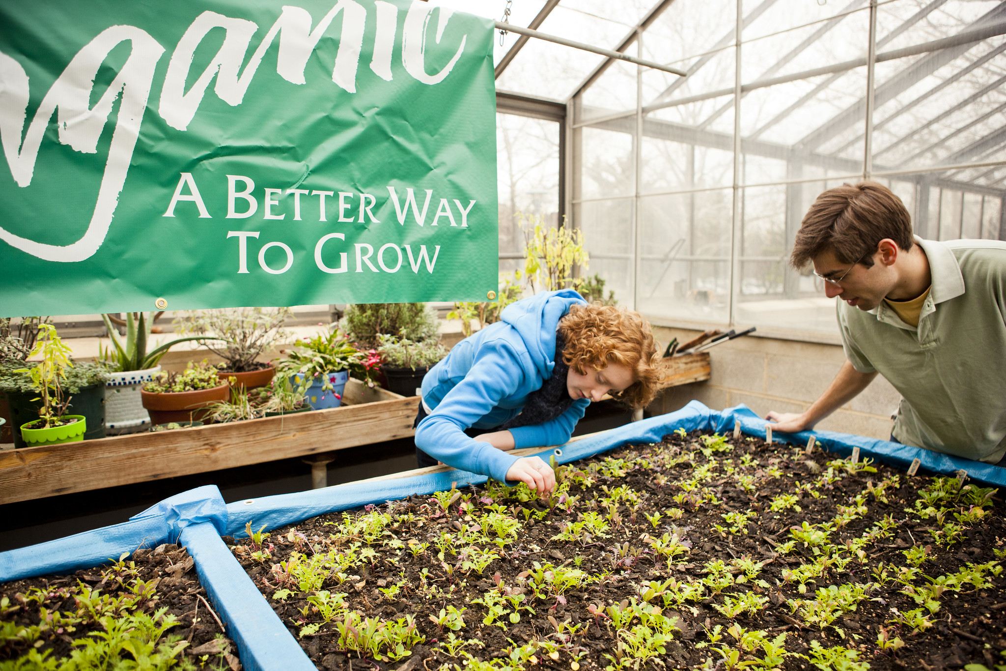 Two students work at the community garden