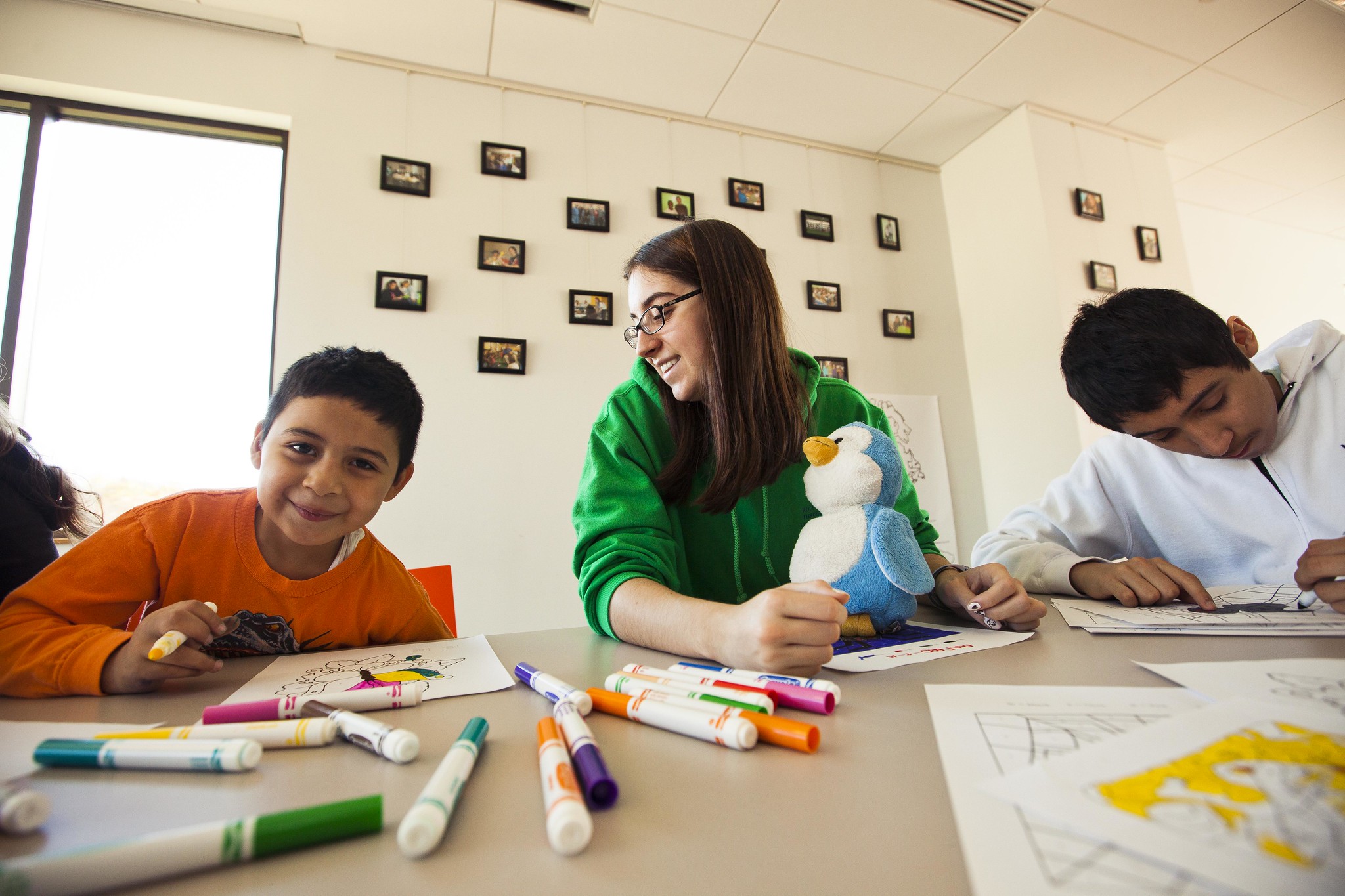 A student assists two children
