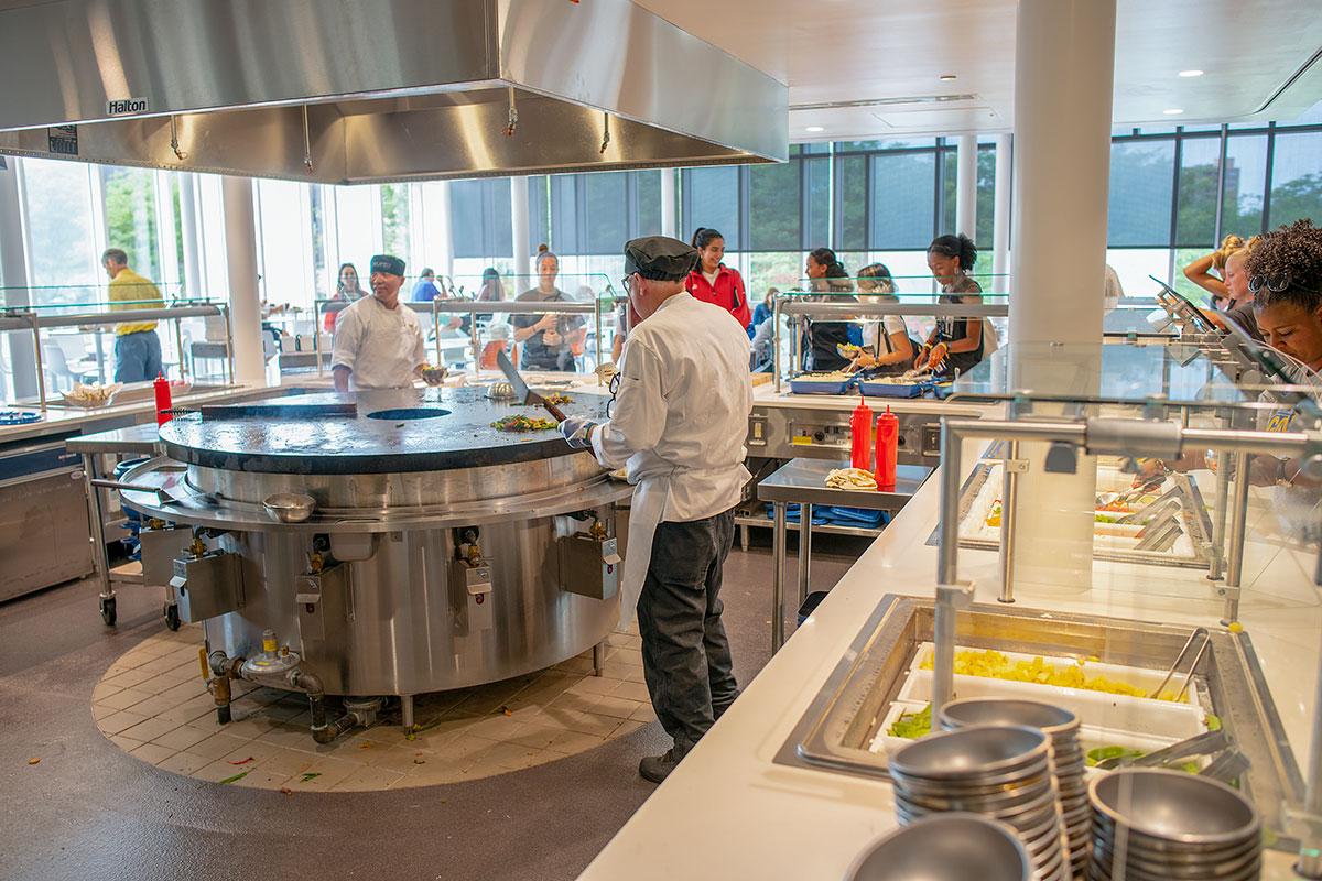 Chefs prepare omlettes at the dining hall